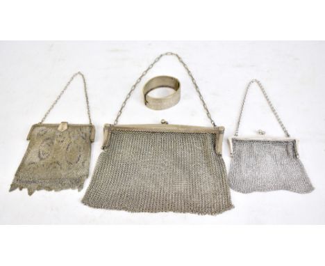 A George V hallmarked silver mounted mesh link purse, Birmingham 1922, two further purses with electroplated mounts and a sil