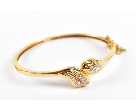 A yellow metal and diamond snap bangle, with Israeli mark to clasp, approx 17.1g.