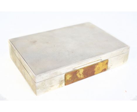 An Elizabeth II hallmarked silver rectangular cigarette box with engine turned detail and applied vacant brass plaque to fron