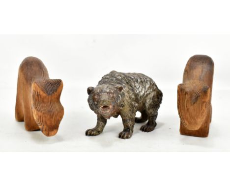 A silver plated model of a bear, unmarked, length 17cm, and two carved wooden stylised animal figures (3).Additional Informat