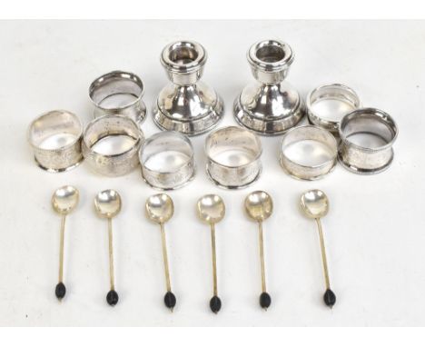 Eight various hallmarked silver napkin rings, a set of six hallmarked silver coffee spoons with bean terminals and a small lo