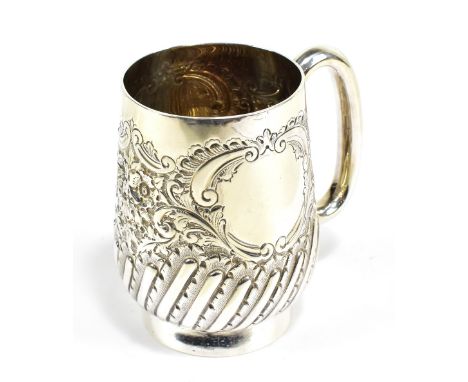 An Edward VII hallmarked silver christening cup with foliate scroll detail, twin vacant cartouches and part gadrooned section