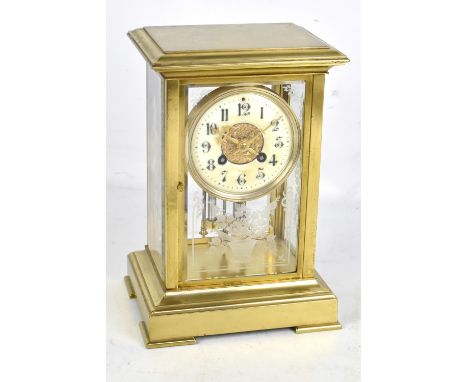 A late 19th century French brass cased mantel clock, the circular dial set with Arabic numerals, with floral etched decorated
