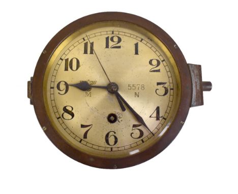 A WWII period Third Reich Kriegsmarine bulkhead clock, the dial set with Arabic numerals, numbered 5578N with engraved emblem