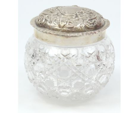 WILLIAM COMYNS; an Edward VII hallmarked silver lidded clear hobnail cut glass vanity jar, the lid with repoussé foliate and 