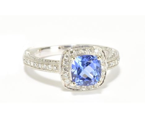 An 18ct white gold tanzanite and diamond ring, with diamonds set to the shank and also inner and outer sides of the shank, si