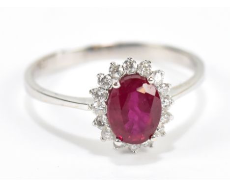 An 18ct white gold ruby and diamond floral set ring, size R, approx 2.7g, sold with receipt from Desire Jewellery.