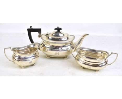 ADIE BROS LTD; a George V hallmarked silver three piece tea set with gadrooned detail, all initialled 'M', length of teapot 2