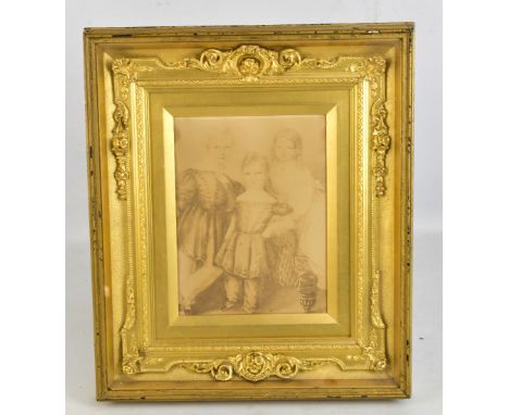 A gilded easel backed picture frame with outer simple rectangular glazed frame, centred with an elaborate further frame (inte