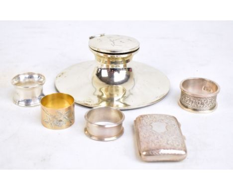 A small mixed group of variously hallmarked silver items comprising cigarette case, four single napkin rings and a large inkw