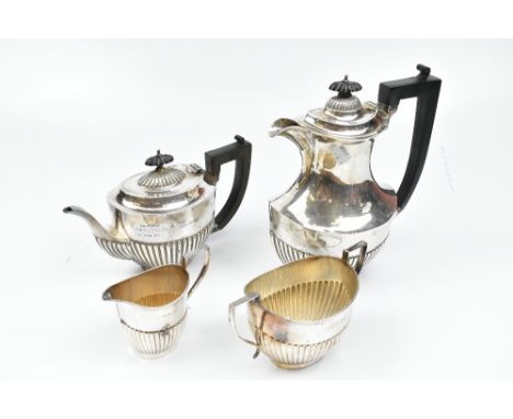 JAMES DEAKIN &amp; SONS; a George V hallmarked silver four piece tea service of part gadrooned oval form, Sheffield 1915, hei