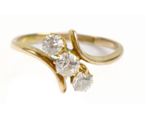 An 18ct yellow gold three stone diamond ring, the central stone weighing approx 0.20ct with 0.10ct either side, ring size is 