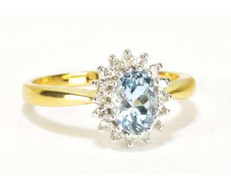An 18ct yellow gold aquamarine and diamond floral cluster ring, the oval aquamarine weighing approx 1.25cts within a border o