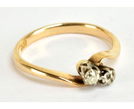 An 18ct yellow gold and old cut diamond two stone crossover ring, size P, approx 2.9g.Additional InformationThe stones are to