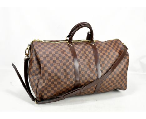 LOUIS VUITTON; a Keepall Bandouliere 55 Monogram macassar Boston bag, with brown leather straps and gold hardware, MB0076, 55