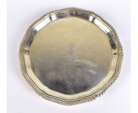 A George VI hallmarked silver waiter, with shaped rim and three scrolling supports, with presentation inscription 'Royal St D