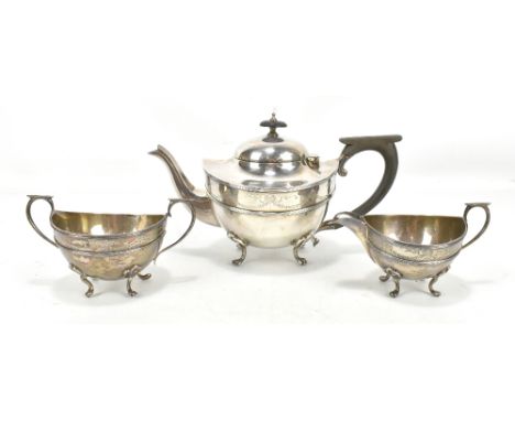 WILLIAM AITKEN; a George V hallmarked silver three piece tea service with engraved ribbon and floral swag detail, all raised 