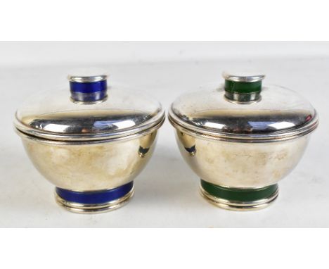 PUIFORCAT; a pair of Art Deco silver plated circular boxes and covers, one with bands of green decoration, the second with ba