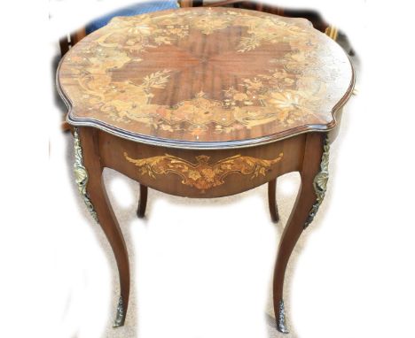 An early 20th century Continental mahogany inlaid centre table with shaped circular top and gilt metal mounts, on square sect