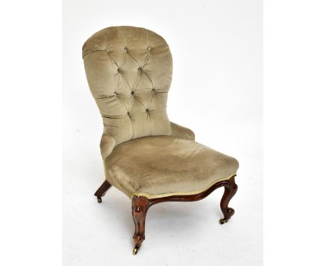 A Victorian button back nursing chair of serpentine outline in pale green upholstery, on cabriole legs to castors.Additional 