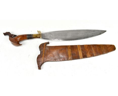 A Philippines barong dagger with carved hilt, blade length 36cm, in wooded scabbard.Additional InformationBlade has some impe