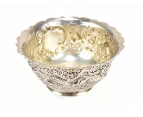 WEST &amp; SON; a Victorian Irish hallmarked silver footed bowl, with repousse and cast decoration depicting hunting dogs and