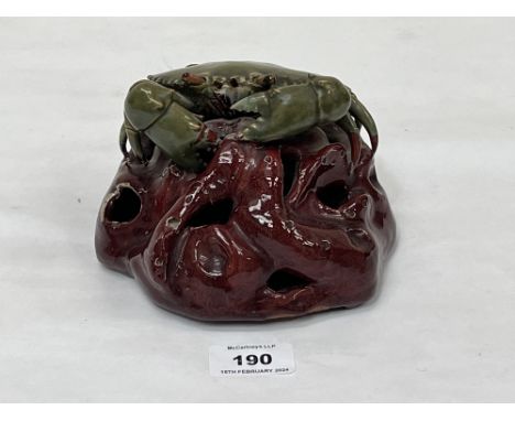 A Continental Palissy type glazed earthenware model of a crab on a rocky base. 6" wide. Damage, losses