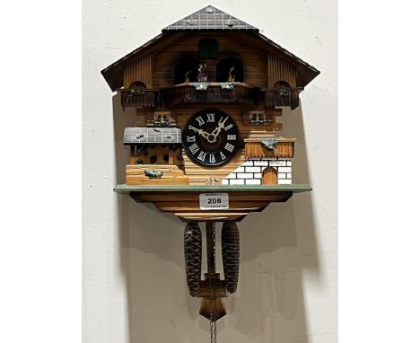 A German cuckoo clock, the two train movement with figure and water wheel automata. 10" wide
