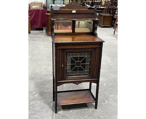 A Victorian mahogany side cabinet with mirrored superstructure, enclosed by a stained glass panel door. 22" wide.