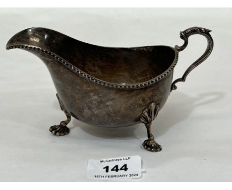 A George VI silver helmet form sauce boat on three shell moulded feet. Birmingham 1948. 6¼" long over handle, 4 ozs 10 dwts