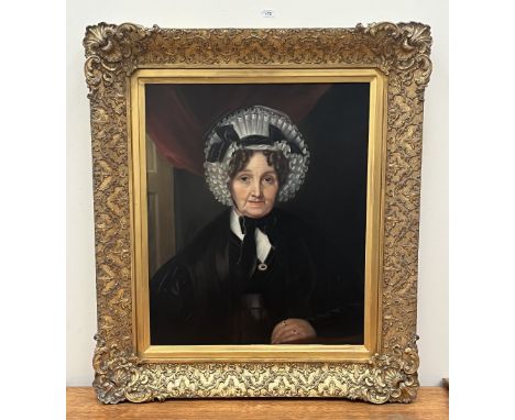 ENGLISH SCHOOL. 19TH CENTURY A portrait of a lady wearing a lace bonnet. Oil on lined canvas 30" x 24"
