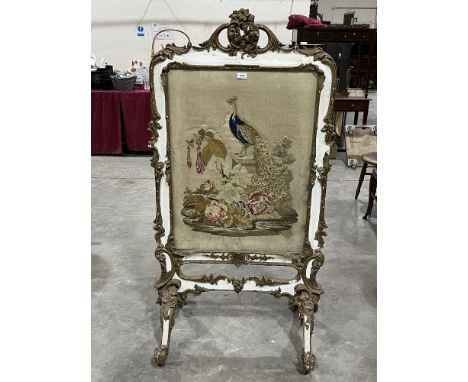 A Victorian parcel gilt gesso firescreen, the woolwork banner worked with a peafowl on a pedestal. 32"w x 59"h.
