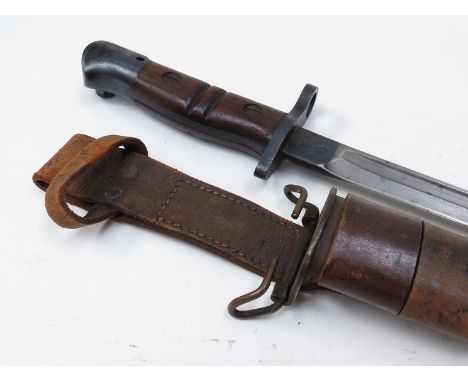 A WWI US M1917 Remington bayonet with wooden grips, 1917 date stamp, 1918 dated scabbard and brown leather frog