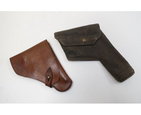 An early 20th Century brown leather pistol holster, a British canvas example and a leather covered brass powder flask (3) 