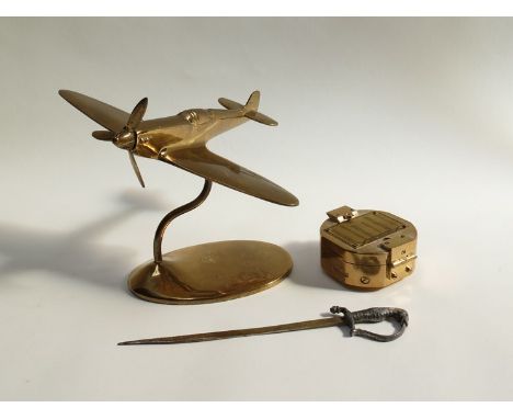 A brass model of a Spitfire on stand, a sword form letter opener and a reproduction compass  (3)