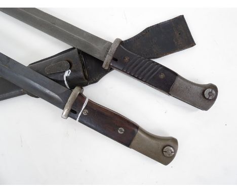 A German K98 bayonet by W.K.C. with scabbard and leather frog, together with another similar (2)