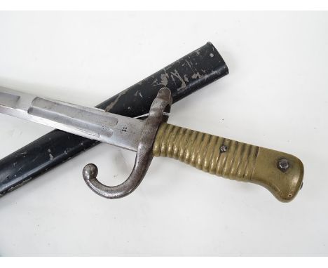 A late variation on a Chassepot bayonet, brass ribbed grip, hooked quillion and multiple fullered straight blade, standard sc