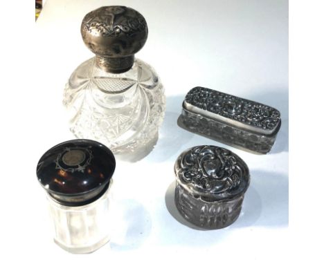 Selection of 4 silver top bottles includes tortoiseshell top 2 trinket jars and a large silver perfume bottle age related wea
