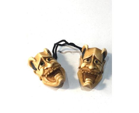 2 Japanese ivory noh mask netsuke of Hannya each measures approx 3.3cm by 2cm attached to a cord 