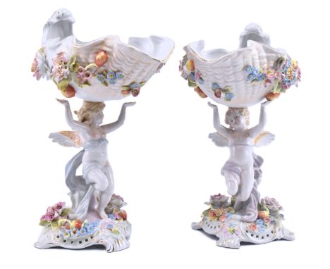 A pair of early 20th century German Sitzendorf style hand painted porcelain cherub putti centrepieces, likely by Schierholz &