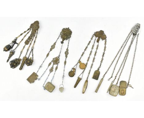 A collection of four early 20th century French metal chatelaines. The lot to include a French metal chatelaine, the pierced c