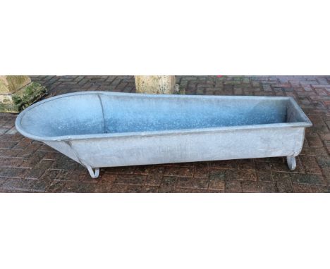 A coffin shaped galvanised trough, by Constantia, raised on scroll supports, 175cm 