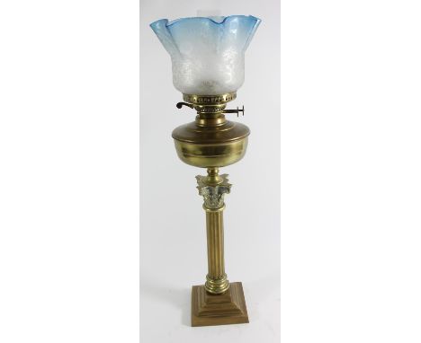 A Victorian brass Corinthian column oil lamp, with Eltex and Duplex adjusters, blue tinged acid etched glass shade, overall h