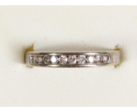 A 9ct white gold ten stone diamond half eternity ring, channel set with brilliant cut stones, M, 2.2gm 