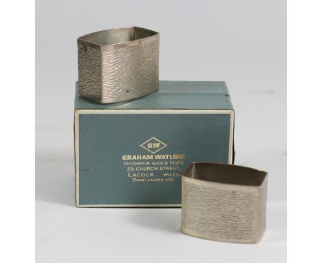 Graham Watling (1930-1996), a pair of silver napkin rings of textured rounded rectangular form, Graham Watling of Lacock, Lon