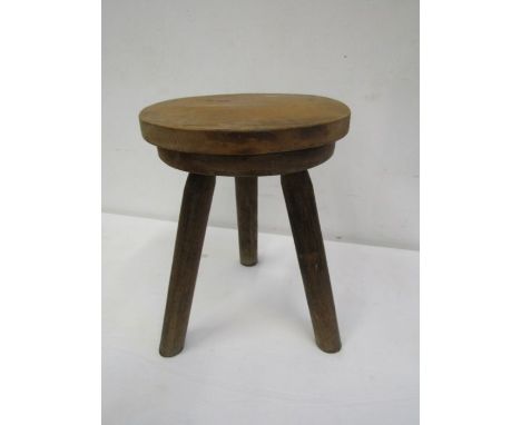 A hardwood vintage milking stool