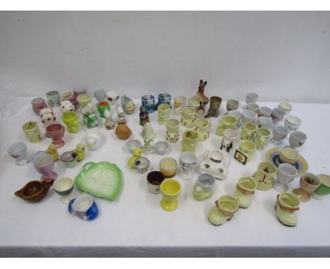 A collection of novelty egg cups, cricket cup and s&amp;p pots, some vintage