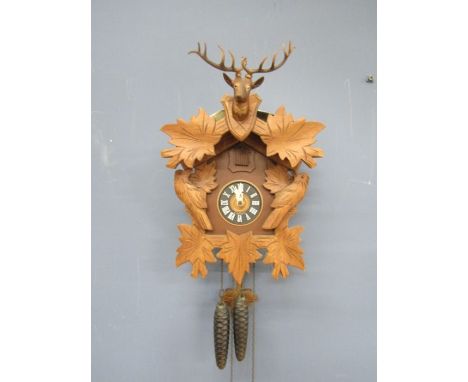 A Black Forest West German cuckoo clock with weights and leaflet 1977