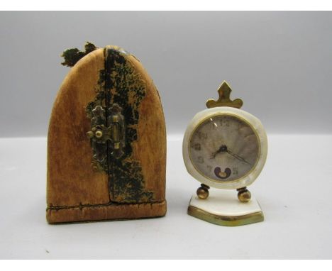 Small travelling clock with brass back and mother of pearl detail in gothic style case 7cm tall (in case)