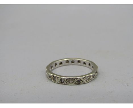 A white metal ring with white stones marked 'CT' size K